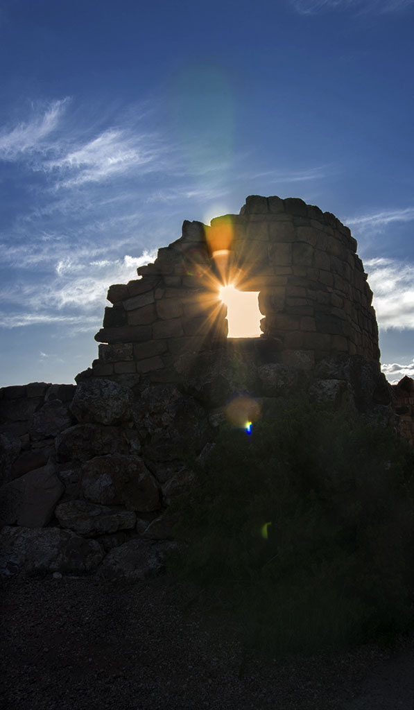 Setting sun peeking through rock formation. Grand Canyon, Arizona.