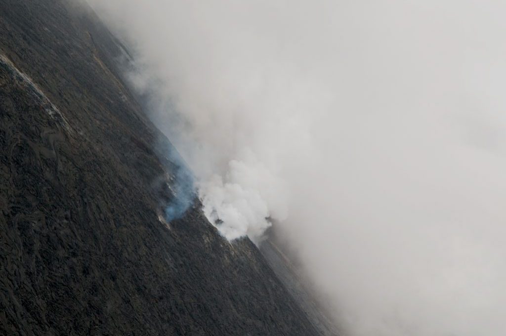 Aerial photography of smoking lava fields of Hawaii. Photo by Alina Oswald.