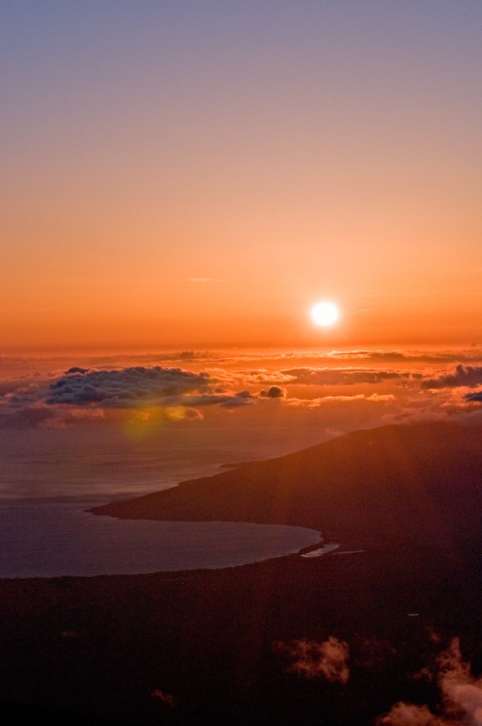 Watching the sunset from above the clouds. Haleakala National Park. Maui, Hawaii. Photo by Alina Oswald.