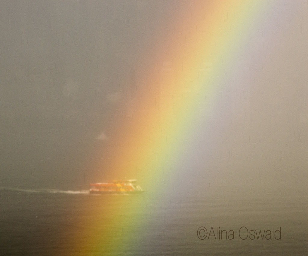 Ferry sailing down the Hudson, through the rainbow. Photo by Alina Oswald.