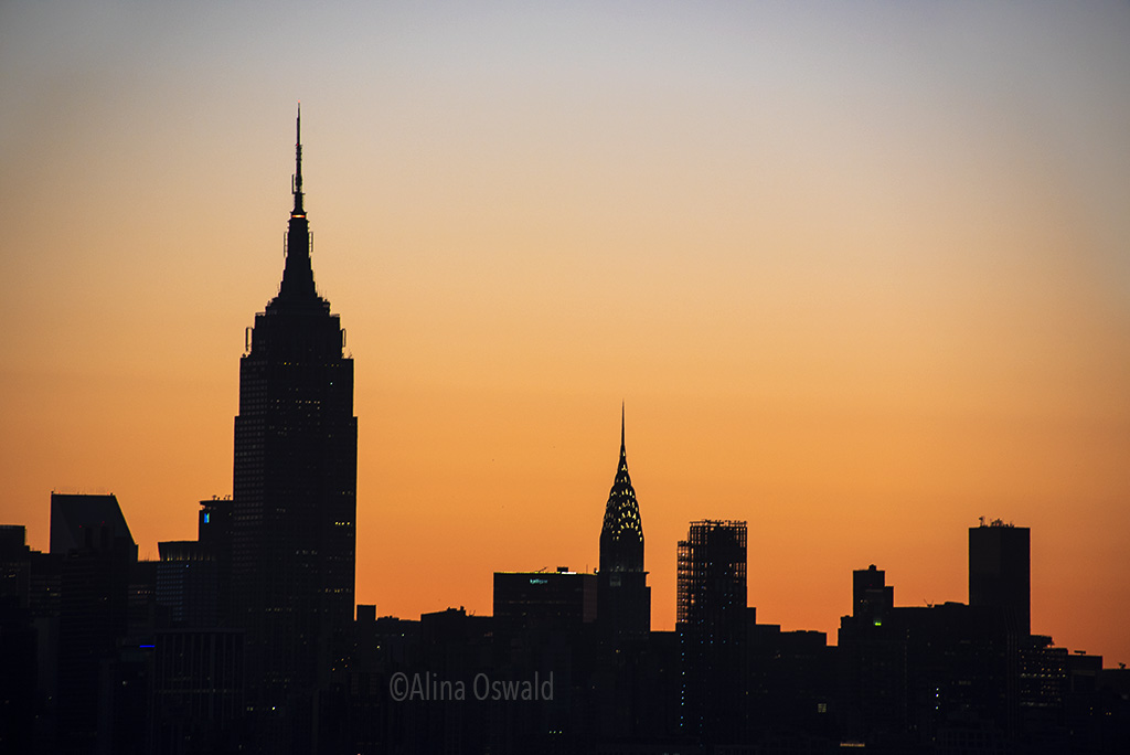 Sunrise light silhouettes Manhattan skyline. A closer look. Photo ©Alina Oswald. All Rights Reserved.