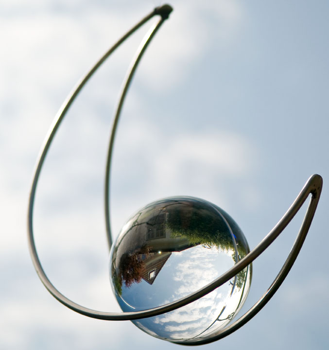Frisian house reflected in glass ball ornament, in Sylt, Germany. Photo by Alina Oswald.