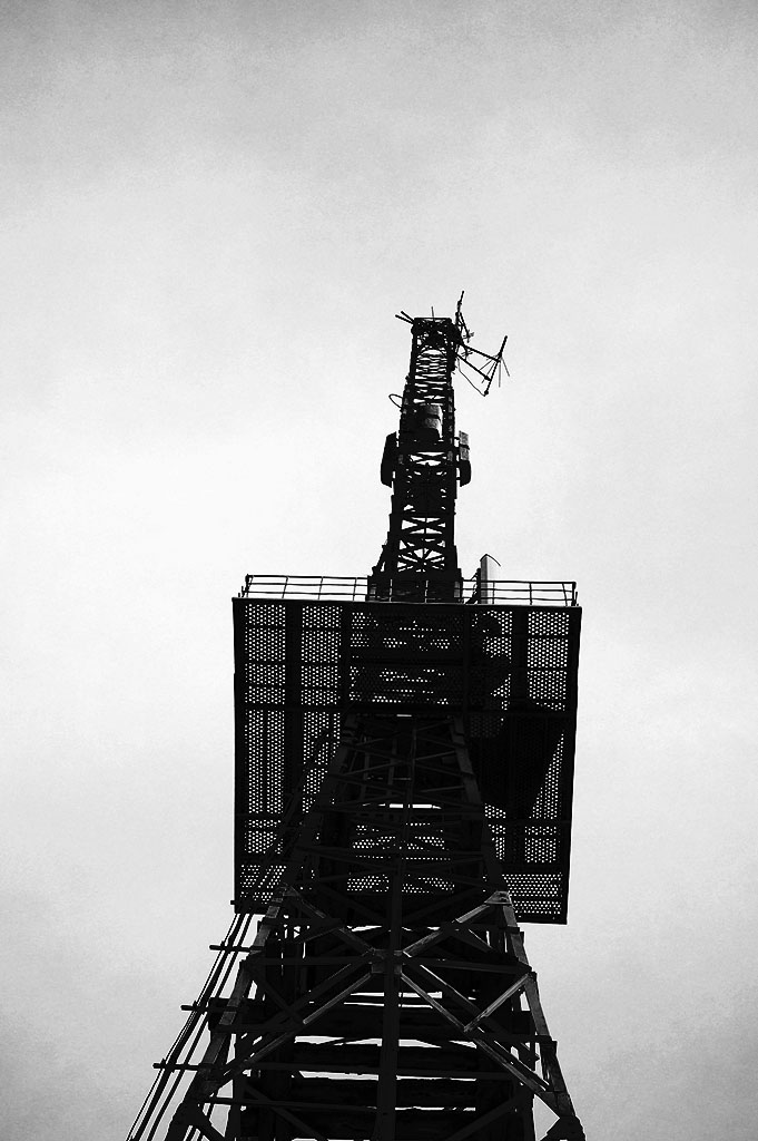 Relay tower against the sky. Black-and-White Photography by Alina Oswald.
