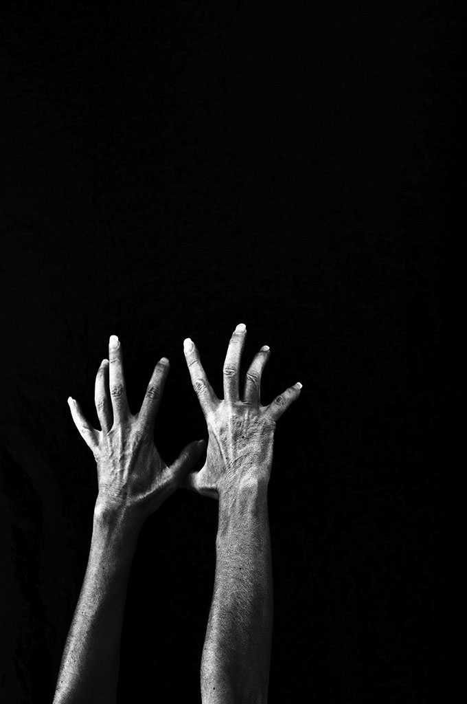 "No Surrender" A hand self-portrait in black and white. ©Alina Oswald.