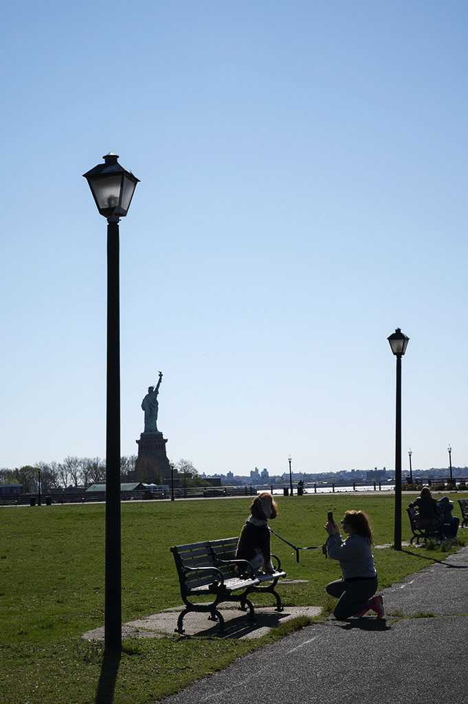 Cute Dog Moments: A lady takes a snapshot of her cute dog in Liberty State Park. ©Alina Oswald.