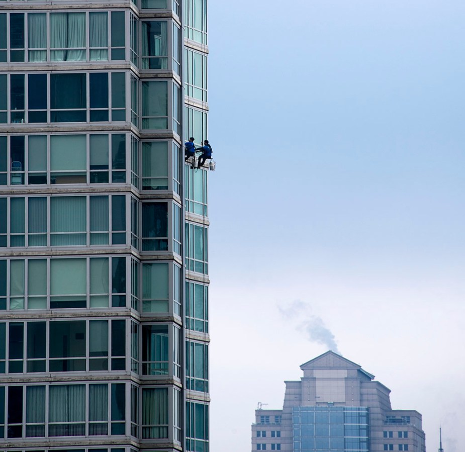 Window cleaning in a time of Covid-19. Upon zooming in, it looks like they're wearing masks. ©Alina Oswald.