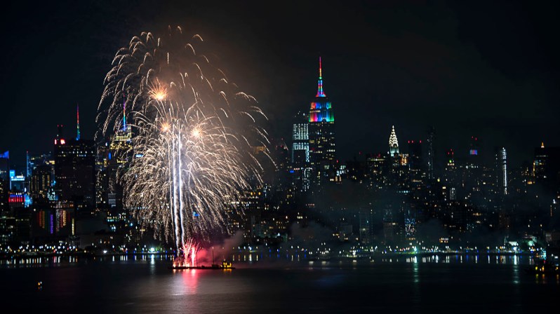 NYC Pride 2020 fireworks next to a rainbow-lit ESB during NYC Pride 2020 evening. ©Alina Oswald.