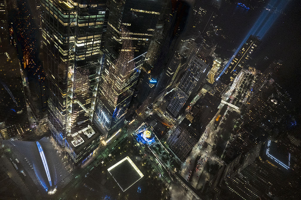 Blue Tribute Lights from the Oculus to the September 11 Tribute Lights in NYC, as seen from One WTC Observatory on 9/11/2021.